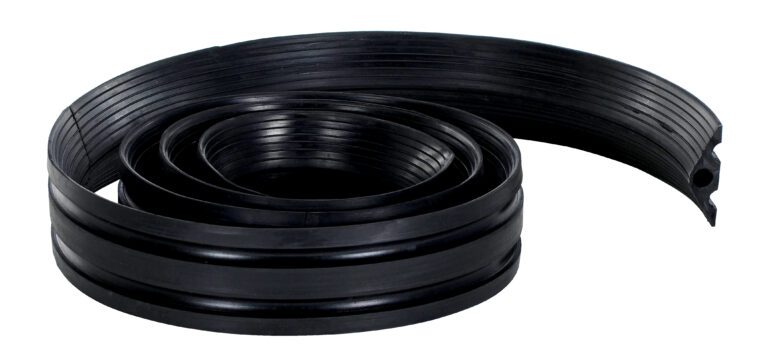 The Vestil Extruded Rubber Cord Protectr 6.6K 12 Ft is a flexible, coiled black rubber strip with a ribbed texture and cylindrical shape, featuring grooves that partially unroll.