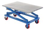 The blue Vestil Mech Scissors Cart features a flat metal platform and four red caster wheels. Designed for lifting up to 1000 lbs, it includes a hand lever for height adjustment, making it robust and user-friendly.
