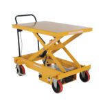 The Vestil Dc Power Hydr Scissor Cart 1K 31.5X47.25 has a yellow hydraulic lift table with a handle, four wheels (including two red ones), and features an X-shaped lift mechanism with a flat top, ideal for lifting heavy objects in industrial settings.