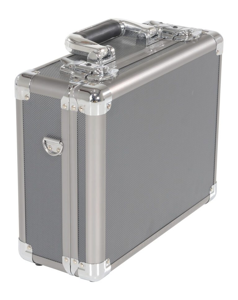 CASE-1310_A.jpg The Vestil Aluminum Carrying Case 13 x 11.5 x 5 showcases a sleek rectangular design with a textured silver finish and reinforced chrome corners, complete with a sturdy top handle and secure side latches, elegantly standing against a white backdrop.