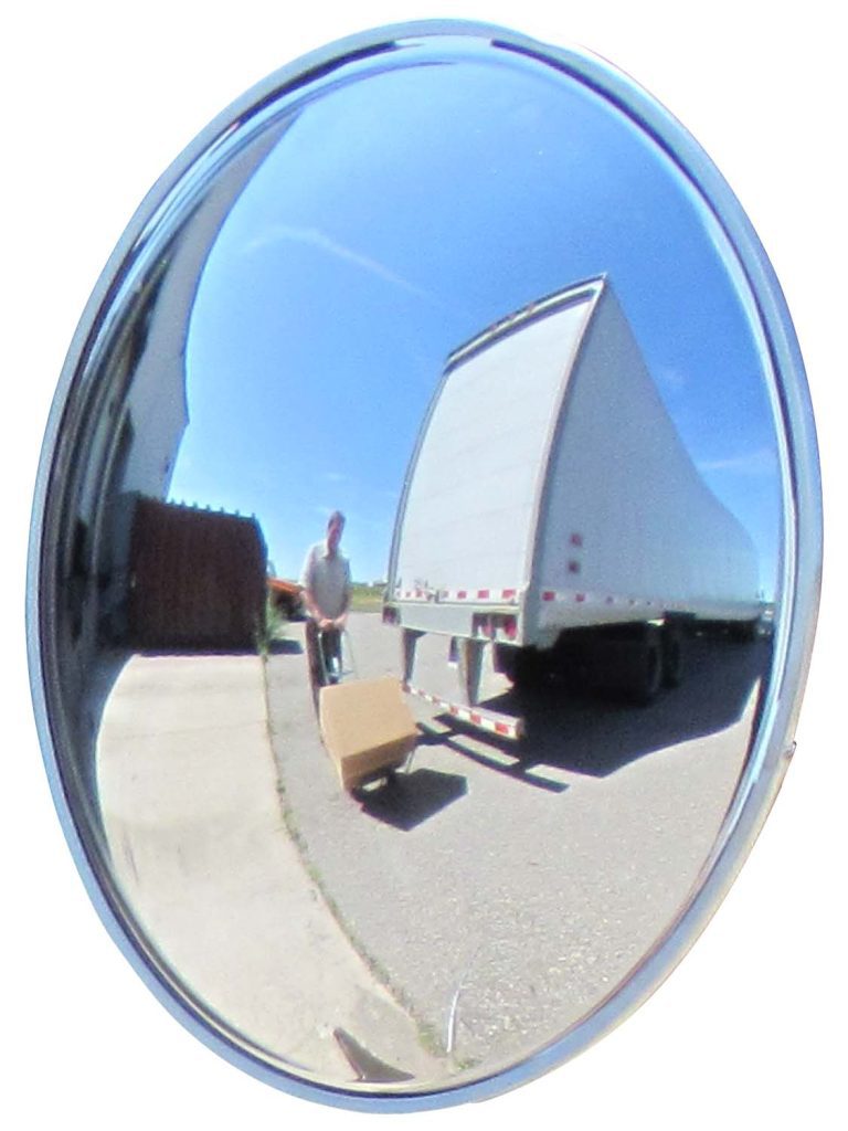In a clear blue sky reflection, a fisheye scene shows a man moving a cardboard box on a dolly by a large truck. This is perfectly captured by the Vestil Convex Mirror Indoor 25-30 Ft 5 In Deep, providing excellent visibility.