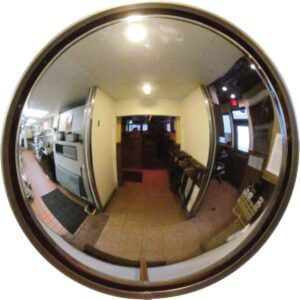 A fisheye view of a narrow, dimly lit corridor shows a Vestil Convex Mirror Outdoor 16-20 Ft 4 In Deep. It reflects the kitchen on the left and the seating area on the right, distorting kitchen equipment and chairs along this elongated passage.