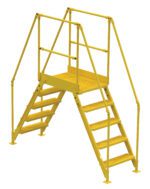 The Vestil Cross-Over Ladder 5 Step 48 H 26 W In boasts non-slip steps, safety railings, and two stair sets leading to a central platform, ideal for safely crossing over obstacles in its industrial yellow design.