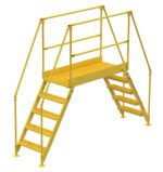 The Vestil Cross-Over Ladder 5 Step 48 H 50 W In features a sturdy yellow metal design with two sets of steps leading to a grated platform and handrails for safety, ensuring secure passage over obstacles.