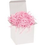 A white open box overflows with MH-USA 10 lb. Light Pink Crinkle Paper (10 Lbs/Case), its fluffy texture cascading playfully over the edges against a plain backdrop.