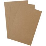 Three sheets of brown cardstock paper, fanned out slightly against a white backdrop, evoke the robust elegance of MH-USA 11 x 17 Heavy-Duty Chipboard Pads (375 Pads/Case).