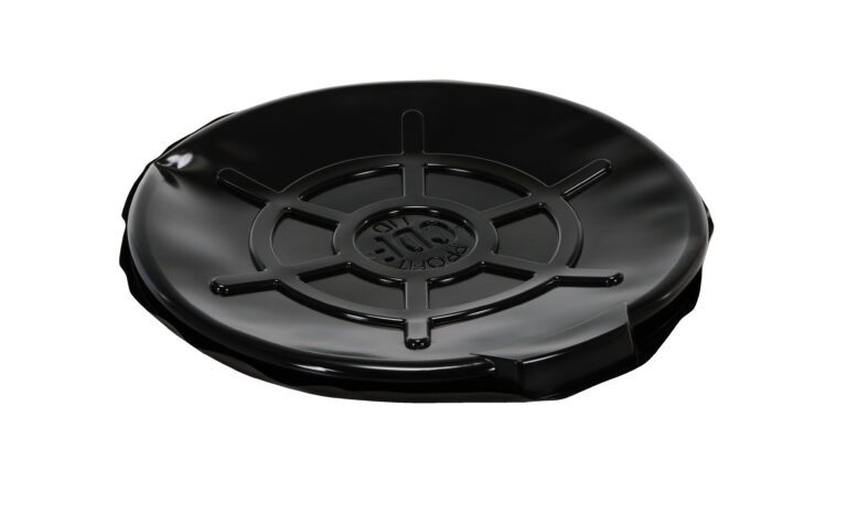 A black vinyl record lies flat against a white background, similar to a Vestil Blk Plastic Drum Cover Open Head 55 Gal. The shiny surface reflects minimal light and features grooves with a central label showing artist and album info.