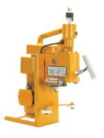 The Vestil High Duty Elec Drum Deheader 1-2 Pass is a yellow industrial machine with a sturdy handle and metal components. It features a control lever, top-mounted power plug, and side label with technical details, all set against a pristine white background for an efficient design.