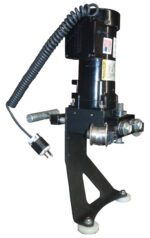 A black Vestil Electric Drum Deheader 3-5 Pass, with a tripod base and rubber feet, has cylindrical parts and an American flag sticker. Nearby is a coiled power cable ending in an electrical plug.