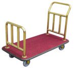 A hotel luggage cart has a red carpeted base, gold-colored metal frames on both ends, and four gray wheels, mirroring the elegance of the Vestil Deluxe Platform Cart 600 lb Capacity.