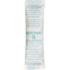 The 1 x 3 1/2 x 1/4 Tyvek® Clay Desiccants come in a white packet labeled DESI PAK with blue text and warnings like DO NOT EAT. These desiccants are crucial for moisture absorption in packaging and are available in a 5-gallon pail containing 700 per case.