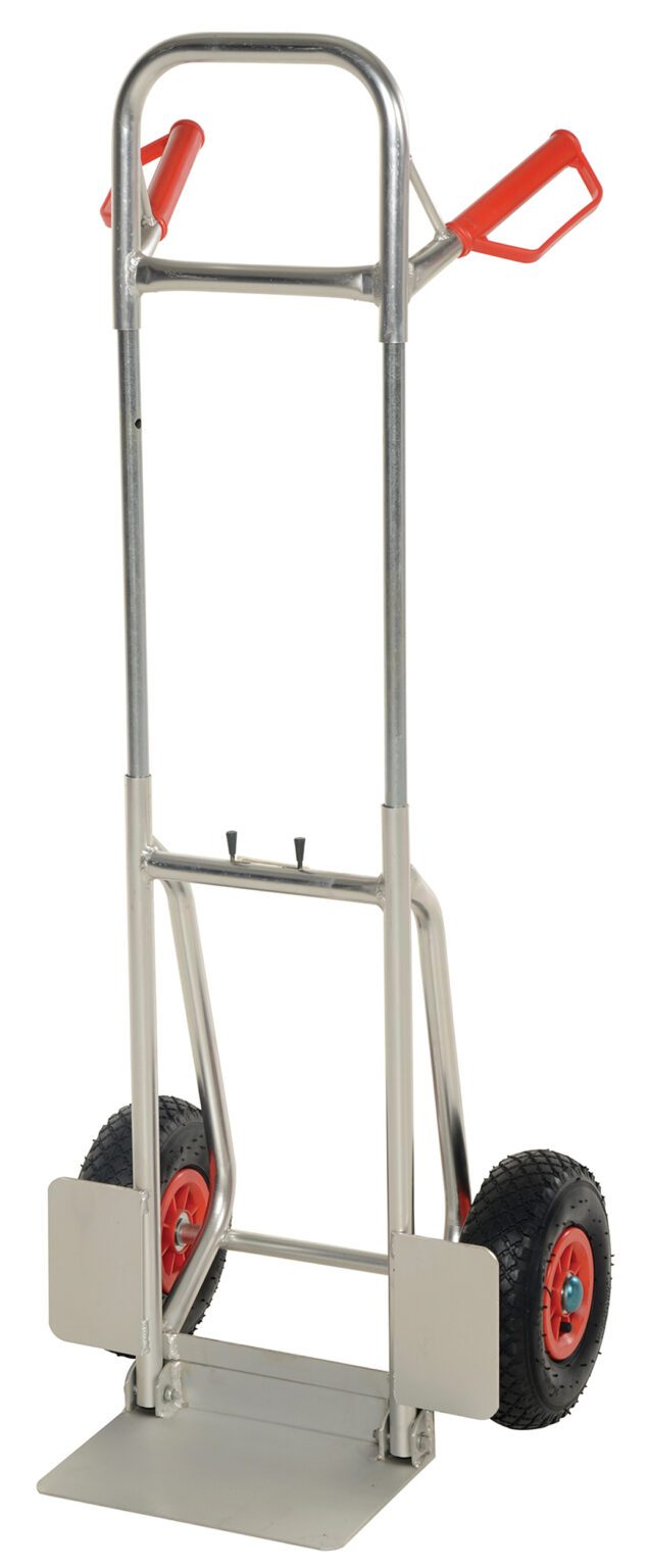 DHHT-250A-FD-PN_A.jpg The Vestil Fold-Down Aluminum Hand Truck-Pneumatic boasts a sleek silver frame, red handles, and durable pneumatic wheels with red rims. Its foldable base is designed to easily transport heavy items.