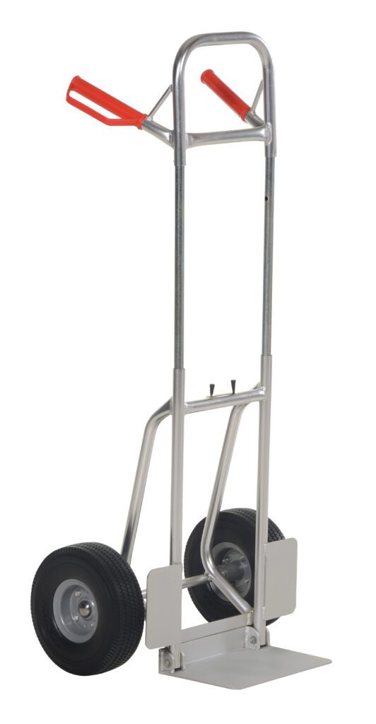 The Vestil Fold-Down Aluminum Hand Truck-Blk Ureth sports a silver frame, two black urethane wheels, and red handles. Its upright design with a flat loading plate ensures rugged traction and efficient transport for various tasks.