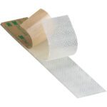 Close-up of a piece of transparent adhesive tape partially peeled from its brown backing, resembling 5/8 x 150 Clear 3M™ SJ4570 Dual Lock™ Low Profile Fasteners. The backing prominently displays the green 3M logo.