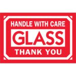 Red and white sign with bold text saying HANDLE WITH CARE GLASS THANK YOU is reminiscent of MH-USAs 2 x 3 labels, Glass - Handle With Care - Thank You, which come in a roll of 500.