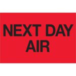 A vibrant red rectangle with bold black text saying NEXT DAY AIR, similar to MH-USA 2 x 3 Fluorescent Red Labels, ideal for urgent shipments.