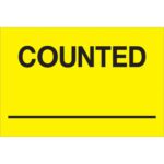 The MH-USA 2 x 3 Counted ___ labels in fluorescent yellow display COUNTED in bold black letters with a horizontal line below, ensuring prominent information visibility. Supplied in rolls of 500.