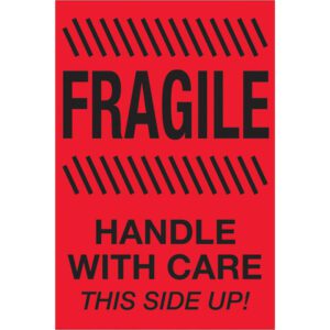 The MH-USA 4 x 6 labels are vibrant fluorescent red with bold black text reading FRAGILE on top, HANDLE WITH CARE beneath, and THIS SIDE UP! at the bottom. Diagonal lines highlight “FRAGILE.” These labels come in rolls of 500.