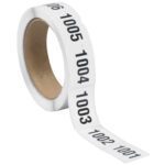 The MH-USA 1 x 1 1/2 roll features consecutive black numbers from 1001 to 1500 on adhesive labels. Its partially unspooled state reveals the inner cardboard core, ideal for organized labeling with a total of 500 labels per roll.