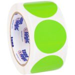 A roll of MH-USA 2 Circles - Fluorescent Green Removable Labels displays large vivid green dots, reminiscent of adhesive tape with a tape logic branded inner reel. Partially unrolled, it reveals the repeating pattern.