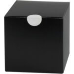 A simple black cube-shaped box with a circular white tab at the top center, much like MH-USA 1 White Perforated Circle Paper Mailing Labels. The box has a smooth, matte finish and appears to be made of cardboard or a similar material.