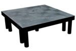 A black square table with a textured surface and round sturdy legs embodies the robust style of the Vestil Dunnage Rack Solid Top - 36 X 36.