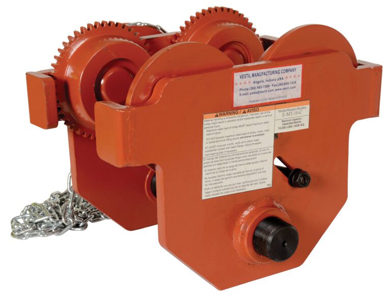 E-MT-10-C_A.jpg The Vestil Eye Manual Trolley Geared 10K Capacity showcases an orange industrial hoist with visible gears, chain, and a manufacturers label. It offers sturdy construction and a prominent warning label for safe heavy lifting.