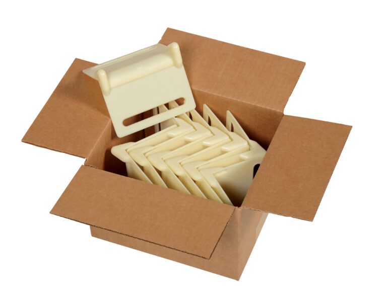 EDGE-N1-12PK_A.jpg An open box contains multiple beige plastic corner protectors from the Vestil Nylon Edge Guards 12 Pack, with one upright and others stacked, each measuring 5.375 x 3.875 inches.