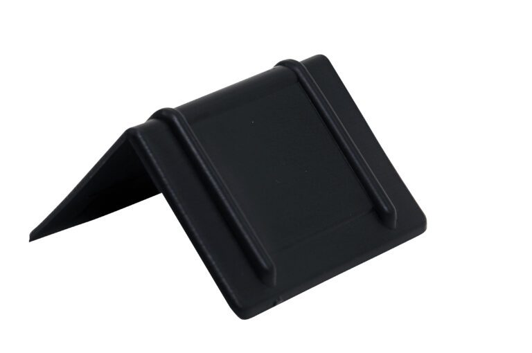 A black, triangular plastic object with a rectangular base and parallel raised ridges resembles a display holder. Its similar to the Vestil Plastic Edge Guards 1000 Pcs 2.25X2.5, providing sturdy support and protection for various items.