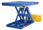 The Vestil Low Profile Electric Lift Table 53X48 showcases a blue hydraulic scissor design with a flat rectangular platform, featuring a yellow control box at the base and metal supports along with a coiled cable beneath the platform.