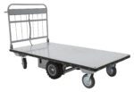 The Vestil Electric Material Handling Cart 36 X 72, No Sides, features a metal frame and dot-patterned flatbed with two large tread rear wheels and two smaller swivel front wheels, ideal for moving heavy items.