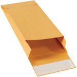 A large 5 x 11 x 2 Kraft expandable envelope with a self-seal flap rests open on a white surface, showcasing its practicality. This product comes in cases of 100 envelopes.