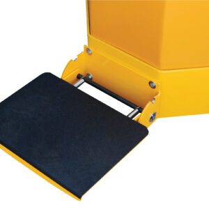 A close-up shows the Vestil Electric Truck Option-Rider Platform Kit with a yellow device and black textured foot pedal, securely mounted on a metal bar with screws, featuring sharp, angular corners.