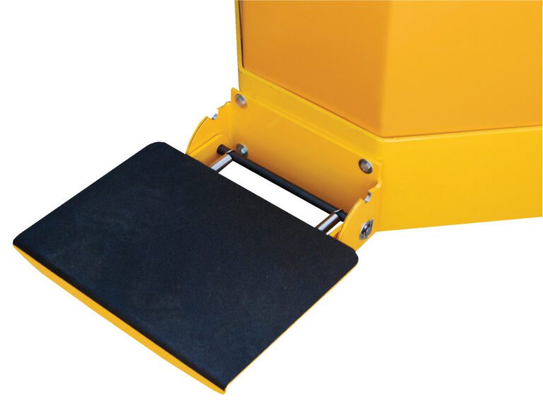 A close-up shows the Vestil Electric Truck Option-Rider Platform Kit with a yellow device and black textured foot pedal, securely mounted on a metal bar with screws, featuring sharp, angular corners.