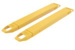 A pair of yellow metal forks for a forklift, similar to the Vestil Fork Extensions 4 X 42 Standard (Pair), are rectangular with angled edges and a hollow end, positioned parallel on a white background.