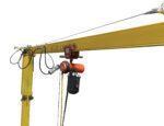 The Vestil Gantry Crane, featuring a 22 ft wire festoon system, showcases its efficiency with a yellow arm holding a black weight via a red hoist. The metal arm, labeled 600 LB CAP, stands out against the white background.