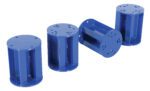 Four blue cylindrical objects with the Vestil Stationary Leg Option are arranged with three upright and one on its side. Each has end holes and vertical slits, perfect for field install tasks.