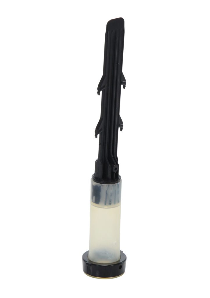 A black and transparent automotive coil pack ignition coil, similar to a Vestil Tubular Flex Insert, stands upright. The base is cylindrical and translucent, while the top section is elongated, black, and features a ridged design.