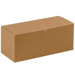 A plain rectangular cardboard box, 14 x 6 x 6, rests against a white backdrop. This Kraft gift box, from the 14 x 6 x 6 Kraft Gift Boxes (50/Case), has a closed lid and a textured surface typical of corrugated packaging.