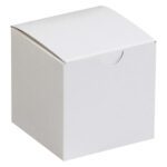 The MH-USA 3 x 3 x 3 White Gift Boxes feature a curved lid and semicircular front notch, perfect for small gifts. Sold in cases of 100, these boxes add an elegant touch to any presentation.