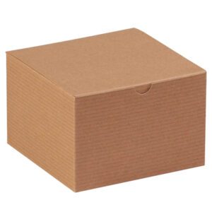 A plain, closed, brown cardboard box with a subtle horizontal line pattern is shown. The 6 x 6 x 4 Kraft Gift Box (100/Case) is angled to highlight its top and two sides, making it an ideal option for bulk purchases.
