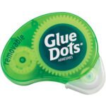 The Dot N Go® Removable Glue Dots® Dispenser (6/Case) has a clear plastic edge displaying its inner workings. The green dispenser, labeled Glue Dots, offers effortless removal for your projects.