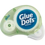 The Dot N Go® Poster Glue Dots® Dispenser (6/Case) in translucent green, labeled mini, exposes a white adhesive tape and a gear-like mechanism inside.
