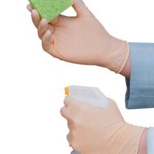 Wearing MH-USA Exam Grade Latex Gloves Powder-Free (Small), a person in a light blue shirt holds a green sponge and white spray bottle with an orange nozzle, set against a stark white background.