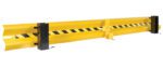 The Vestil Guard Rail System Drop In Yel 111 In is a robust yellow safety barrier with black stripes and end caps, ideal for industrial or warehouse use. Its design includes bolt attachments to keep it securely in place.