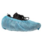 A single black shoe is covered with a blue disposable shoe cover, typically used for protection in clean environments. The cover is elastic and features a patterned edge.