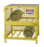 A yellow metal storage cage, similar to Little Giant Gas Cylinder Storage Units, boasts a Danger Flammable sign on the front. It features mesh sides and a secure latch to accommodate two large gray cylinders on its shelves.