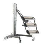 The Vestil Heater Infrared 3 Panel 230V-1Ph is portable and features three vertically stacked, adjustable heating elements. Its mounted on a wheeled stand with vertical support, providing a sturdy base and smooth mobility with four caster wheels.