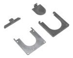 Four flat, gray metal brackets, possibly components of the Vestil Removable Bollard Base Additional, are displayed on a white background. Each bracket has varied shapes and notches indicating their use in assembly or as support structures.