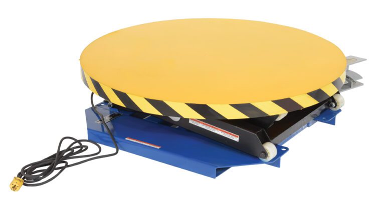 A Vestil Powered Lift Table, 2000# capacity, features a manual carousel with a large round yellow platform with caution stripes. It has a hydraulic scissor design and includes a power cord with a yellow plug on the side.